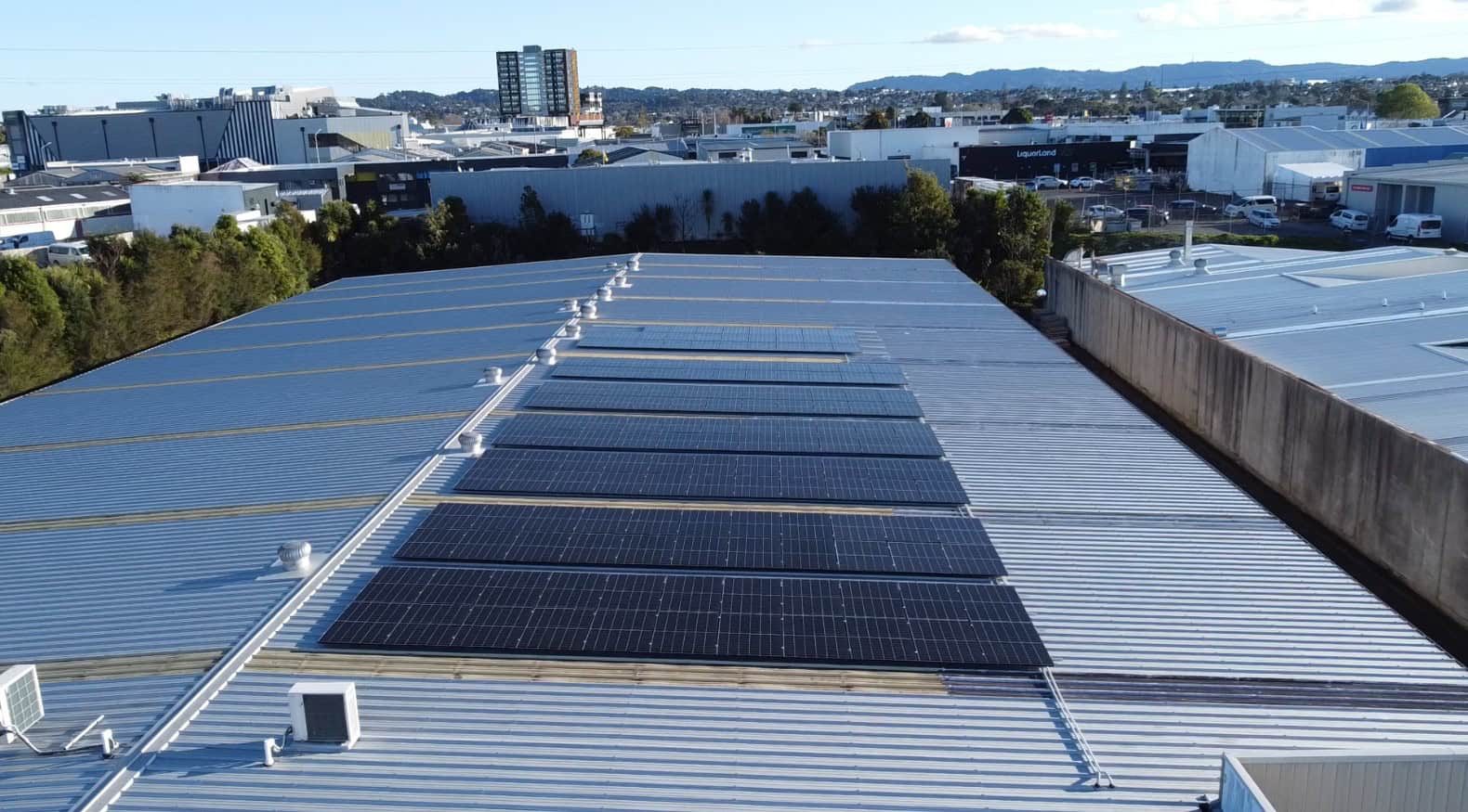 Side angle view of solar panels on commercial property in Auckland, with AVID Solar.